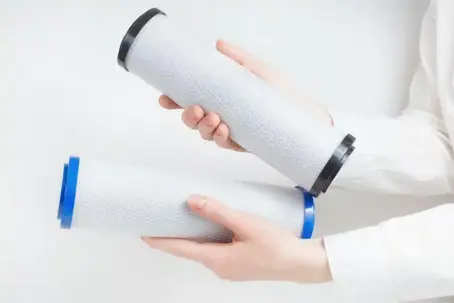 A person holds two water filters