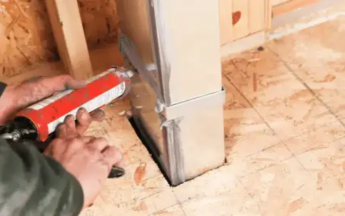 Applies sealant around a metal frame